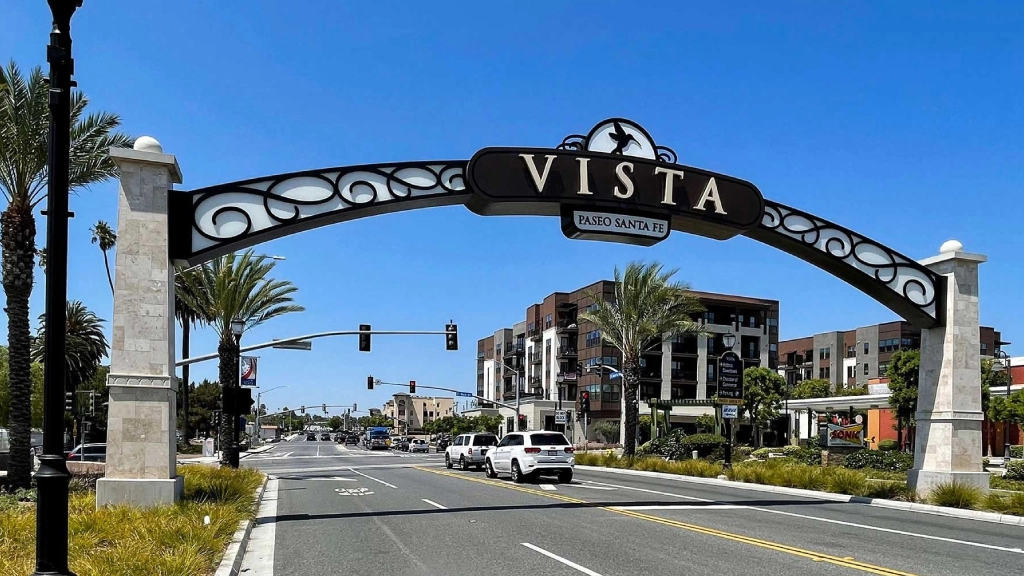 Luxury black car traveling from LAX toward Vista