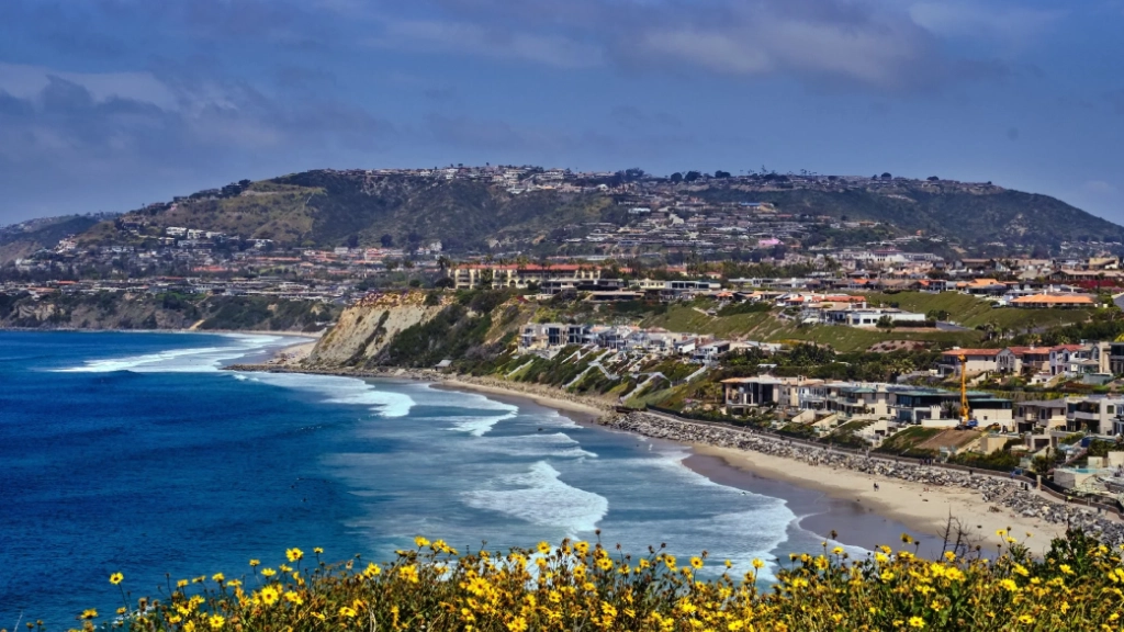 Luxury black car traveling along the coast toward Dana Point