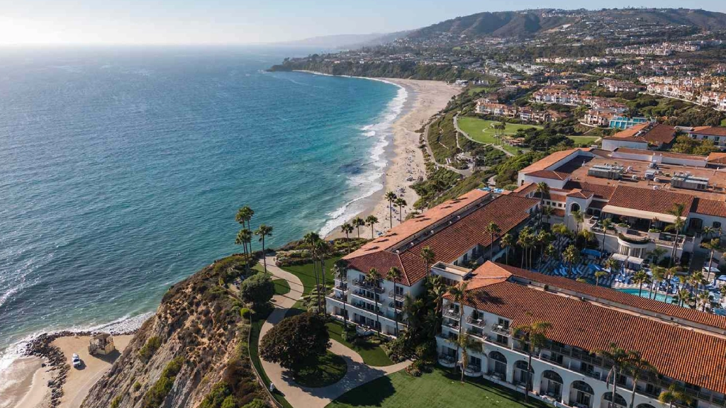 Luxury black car traveling toward Dana Point along the Southern California coast